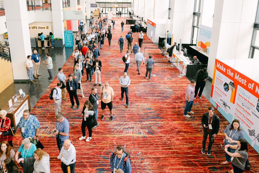 Attendees moving through the busy expo concourse