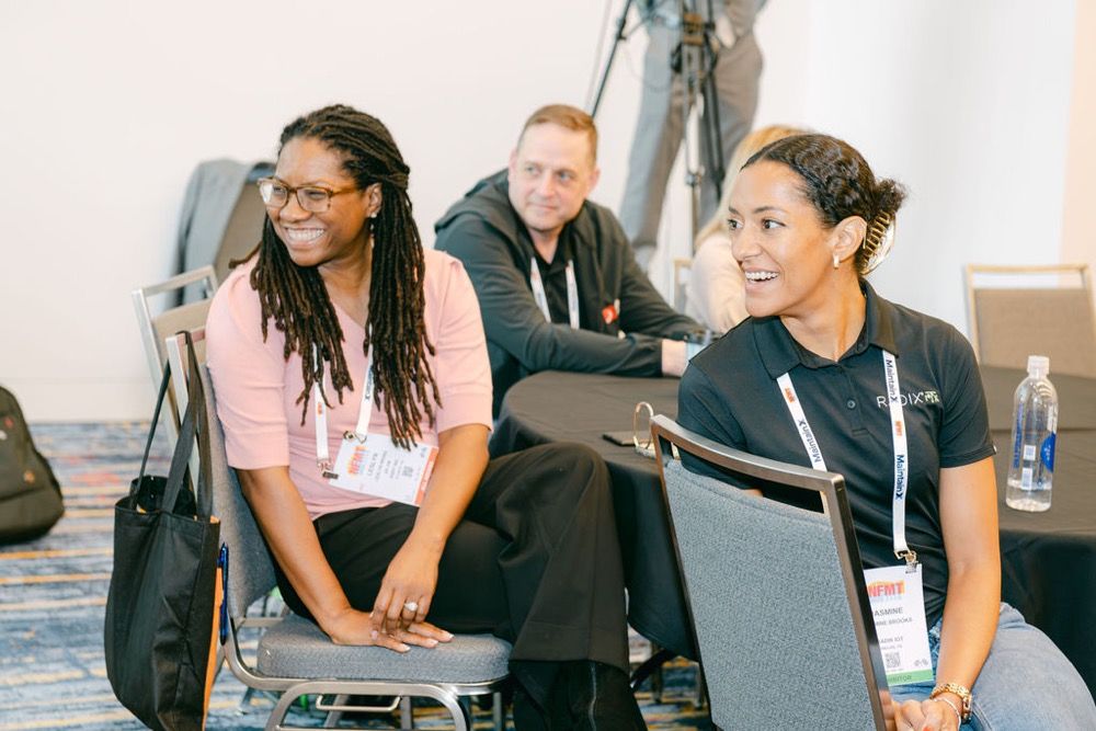 Two attendees in conversation between sessions
